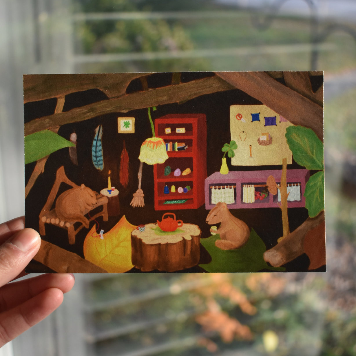 Closeup of postcard featuring chipmunks enjoying winter